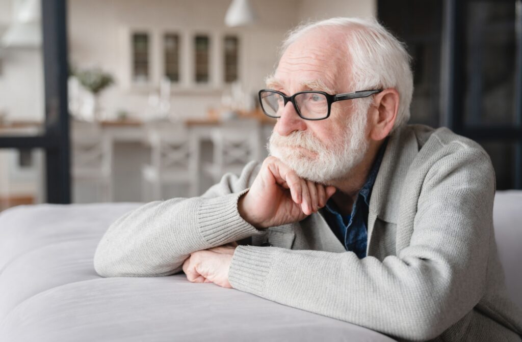 An older man is looking out into the distance bored and isolated.